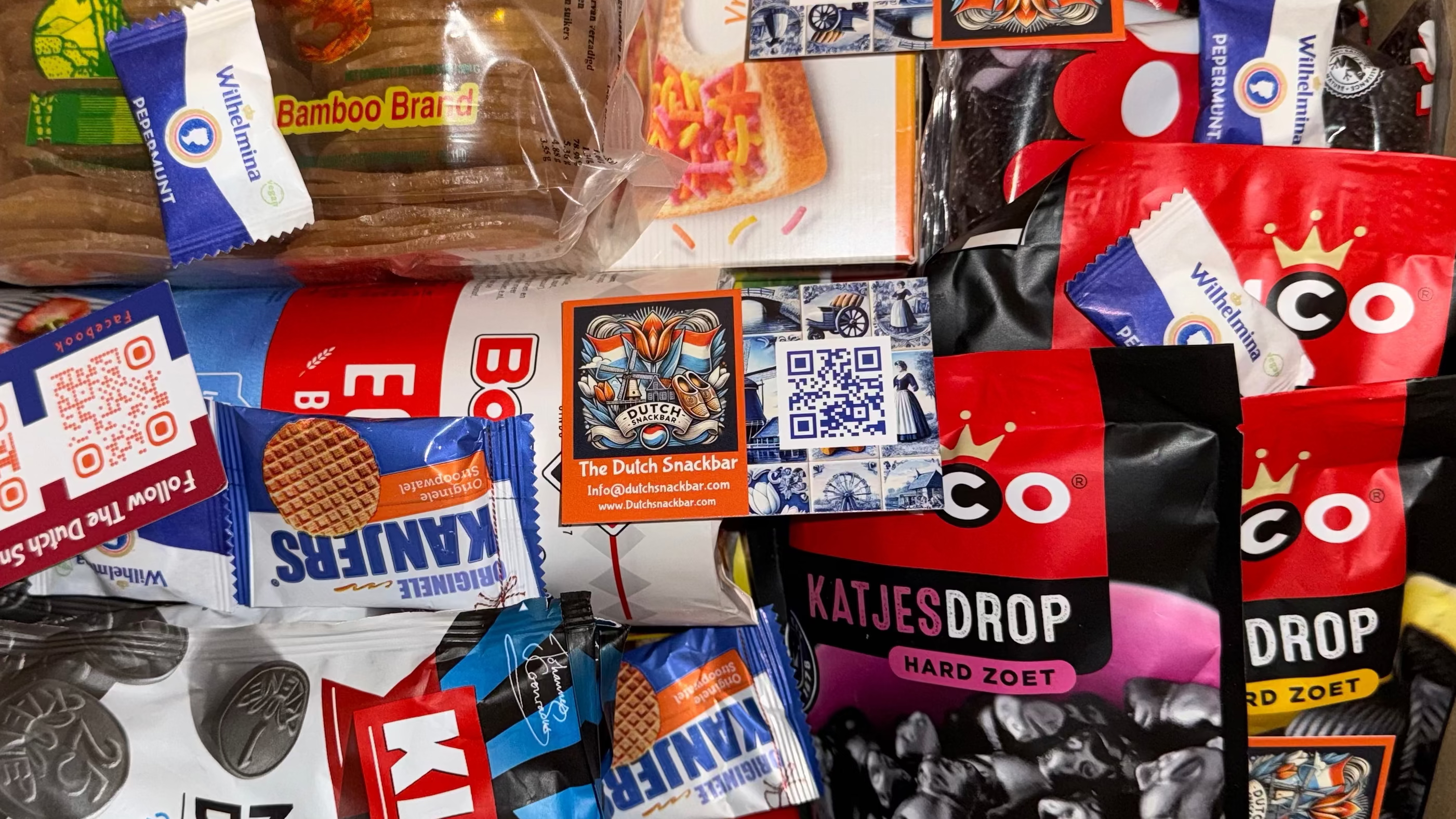 Assorted snack packages with visible brand logos on a colorful background